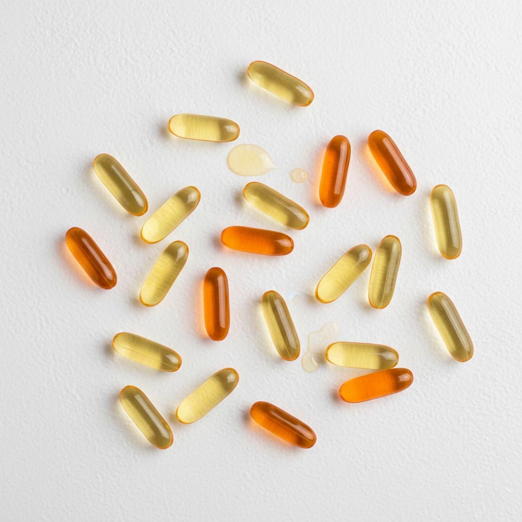 Yellow and orange softgel capsules for vitamins, omega oils, and nutritional supplements