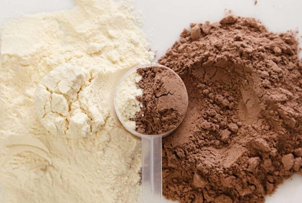 Scoop of vanilla and chocolate protein powder showcasing premium protein supplement ingredients from Pure Nutra Labs