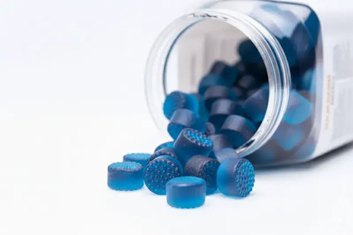 Blue superfood gummies in a supplement bottle for private label gummy manufacturing
