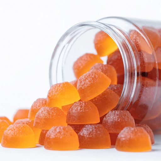 Orange superfood gummies in a supplement bottle for private label gummy manufacturing